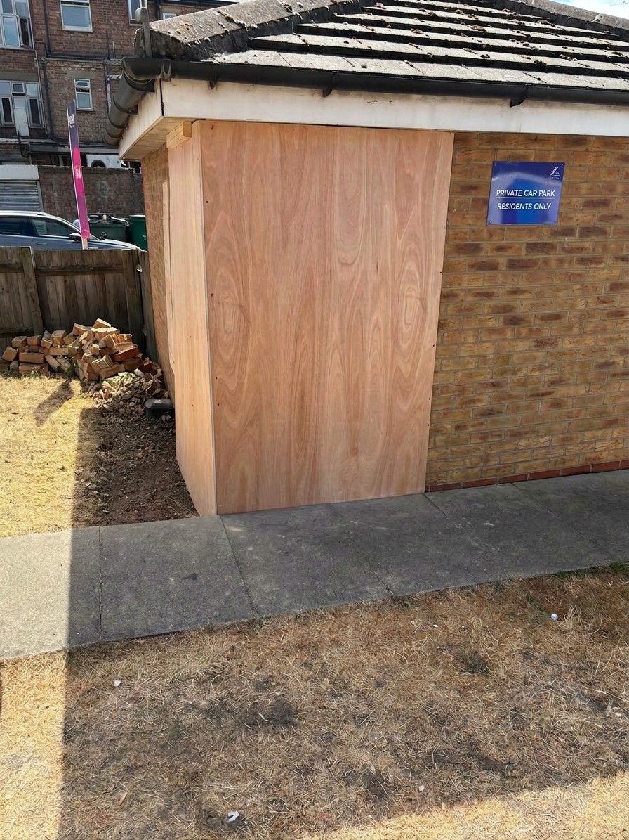 Damaged opening boarded up with plywood to secure the building overnight